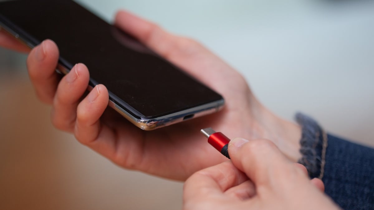 Akku aufladen: Rot-schwarzes Ladekabel mit USB-C wird in Smartphone gesteckt